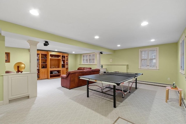 recreation room with light carpet, ornate columns, a baseboard radiator, and recessed lighting