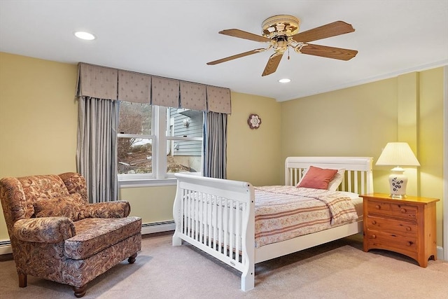 carpeted bedroom featuring a ceiling fan, a baseboard radiator, and recessed lighting