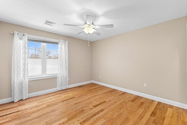 empty room featuring ceiling fan and light wood-type flooring