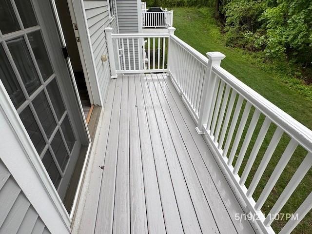 wooden deck featuring a yard