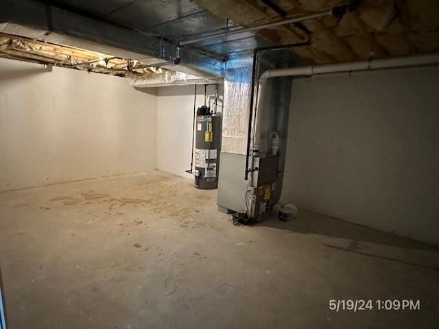 basement featuring heating unit and gas water heater