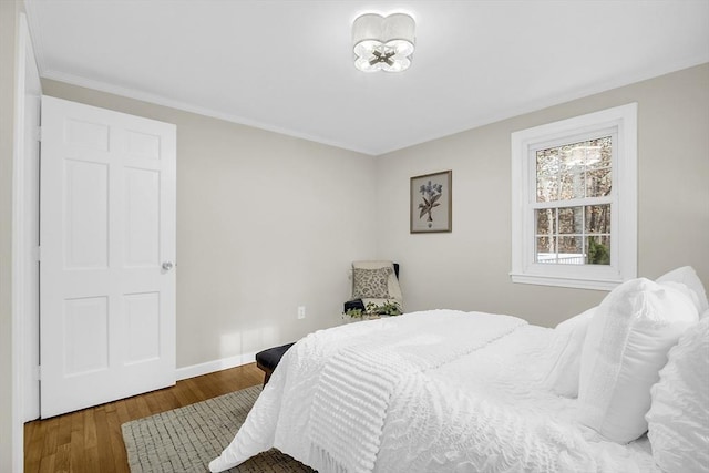 bedroom with hardwood / wood-style flooring and crown molding