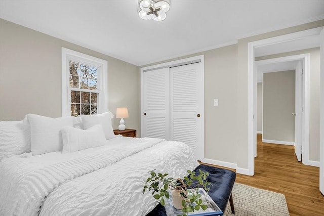 bedroom with a closet and hardwood / wood-style flooring