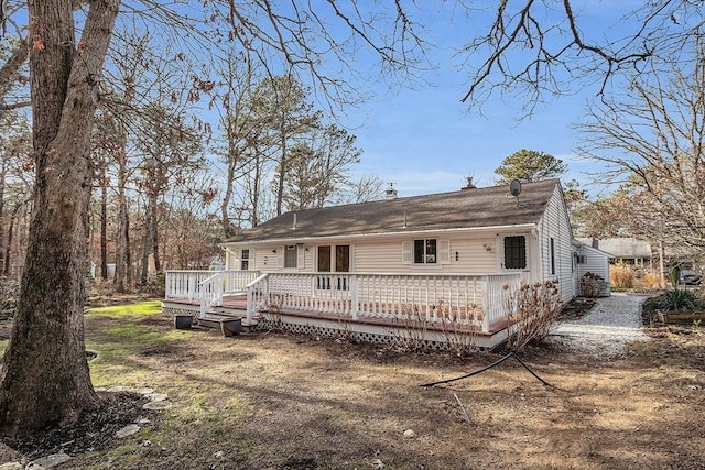 view of front of home with a front yard and a deck