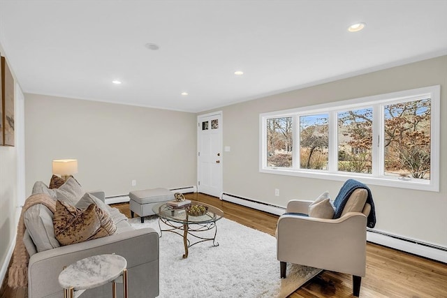 living room with light hardwood / wood-style floors and baseboard heating