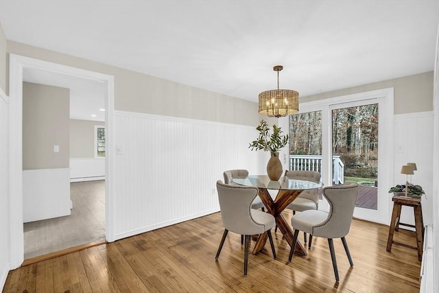 dining room featuring wood-type flooring and a notable chandelier