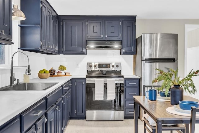 kitchen featuring decorative backsplash, sink, stainless steel appliances, and blue cabinets