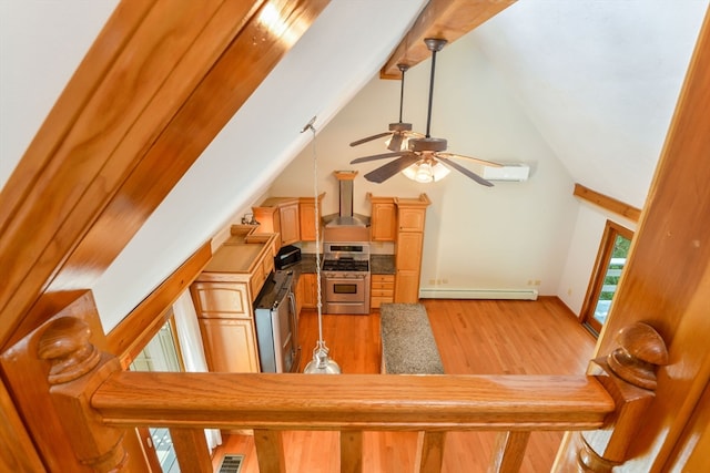 interior space featuring a baseboard heating unit, ceiling fan, hardwood / wood-style floors, and high vaulted ceiling