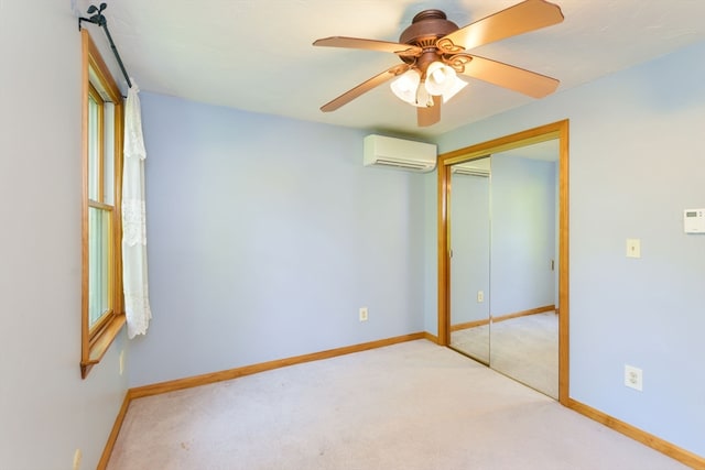 unfurnished bedroom with light carpet, a closet, ceiling fan, and a wall mounted air conditioner