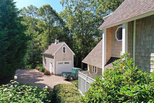 view of property exterior featuring an outdoor structure and a garage