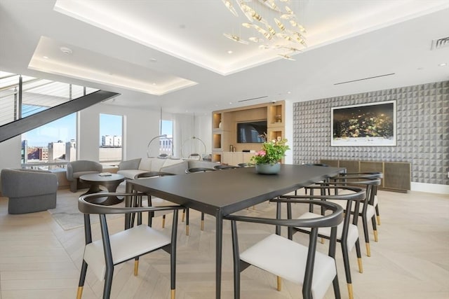 dining room featuring a tray ceiling and an inviting chandelier