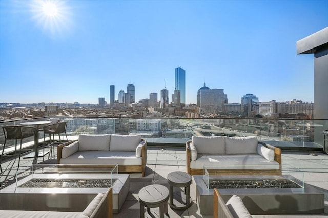 view of patio / terrace with an outdoor living space with a fire pit