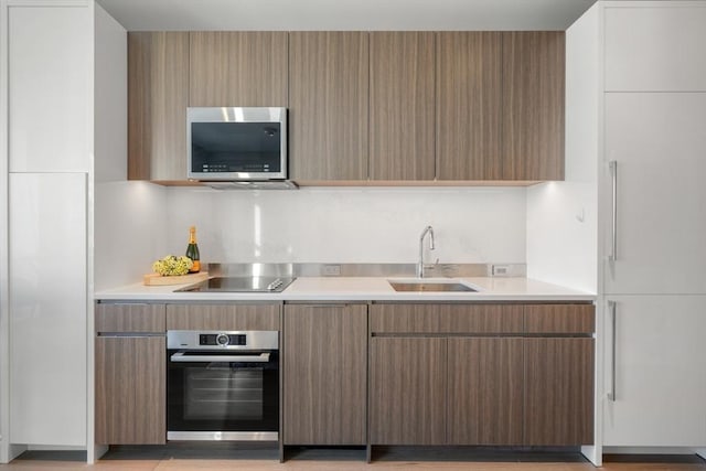 kitchen with backsplash, stainless steel appliances, and sink