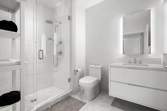 bathroom with a shower with door, vanity, and toilet