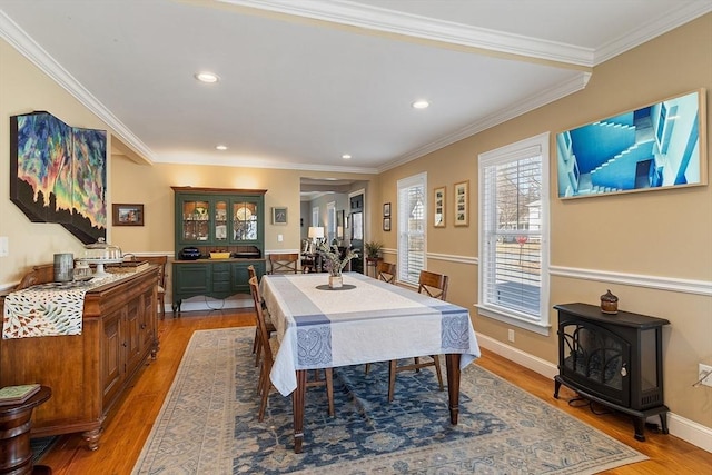 dining room with recessed lighting, baseboards, light wood-style floors, and ornamental molding