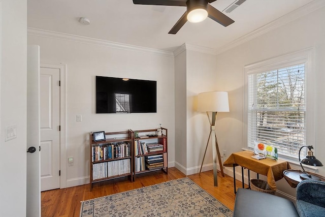 interior space featuring crown molding, wood finished floors, visible vents, and baseboards