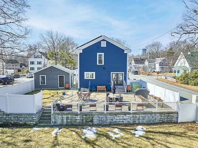 rear view of property with a patio area, a residential view, entry steps, and a fenced backyard