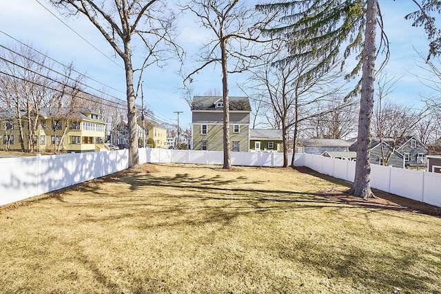 view of yard with a fenced backyard and a residential view