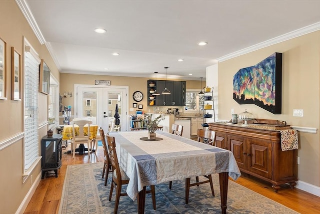 dining area with recessed lighting, french doors, crown molding, and light wood-style floors