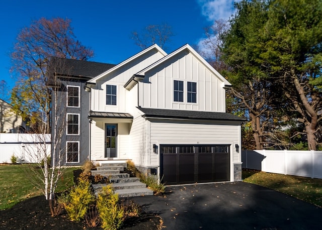 modern inspired farmhouse with a garage