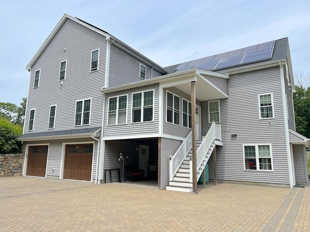 364 Chestnut Hill Rd, Millville, MA 01529 - back of house featuring roof mounted solar panels, a garage, stairway, and decorative driveway