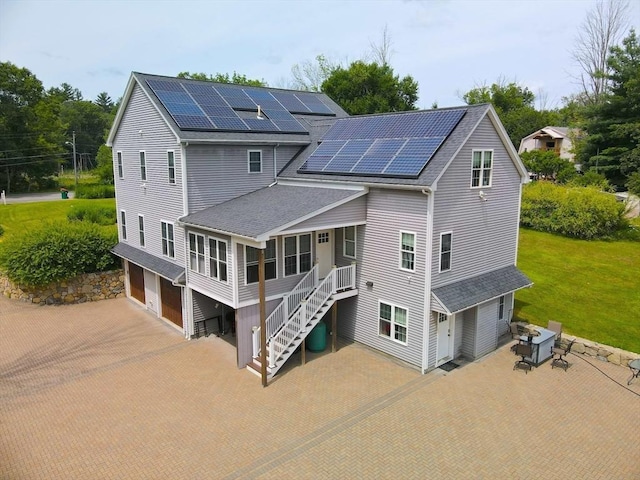364 Chestnut Hill Rd, Millville, MA 01529 - back of house with roof with shingles, roof mounted solar panels, stairs, a garage, and decorative driveway