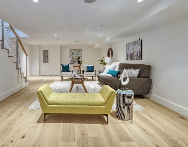 living room featuring electric panel and light wood-type flooring