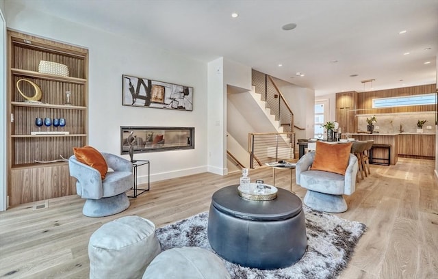 living area with light hardwood / wood-style floors