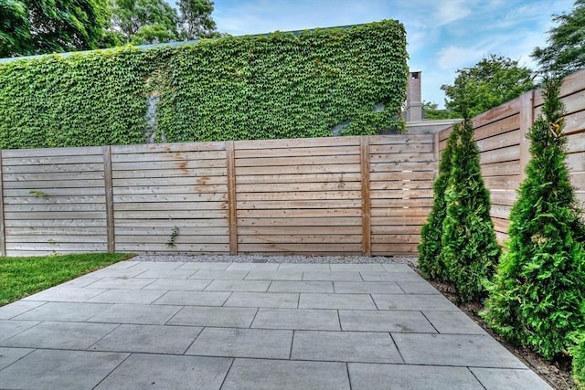 view of gate featuring a patio