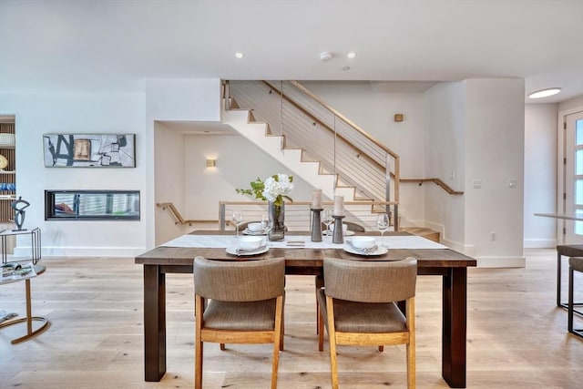 dining space with light hardwood / wood-style floors