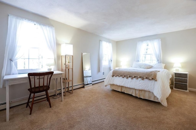 bedroom with baseboards, baseboard heating, and light colored carpet