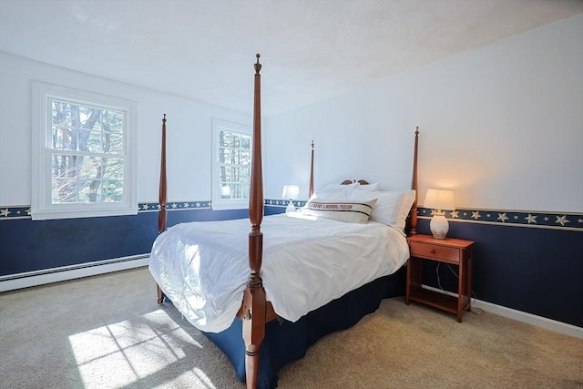 carpeted bedroom with baseboards and a baseboard heating unit