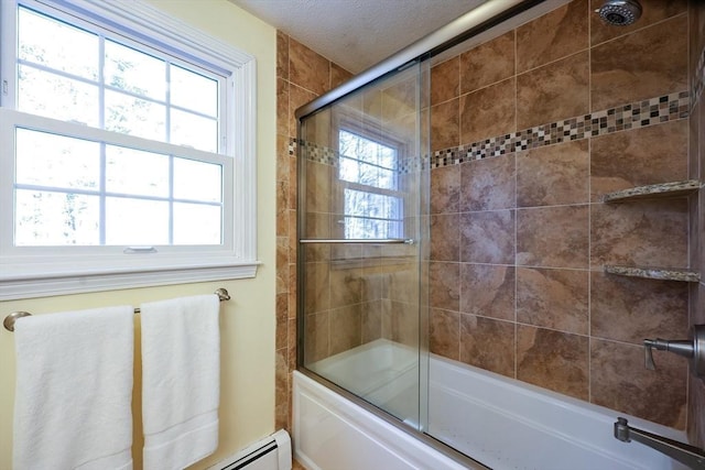 full bath featuring a textured ceiling and shower / bath combination with glass door