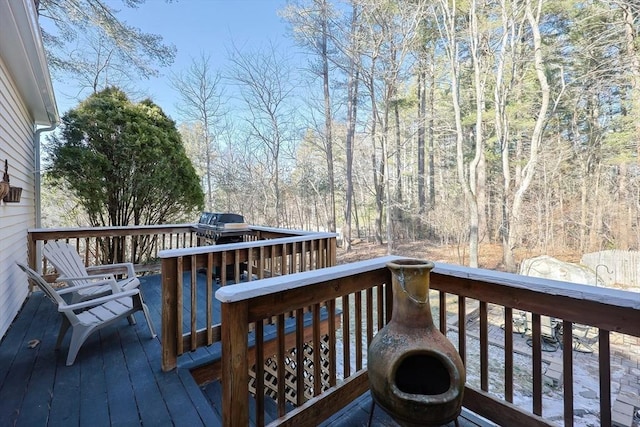 wooden terrace with a wooded view