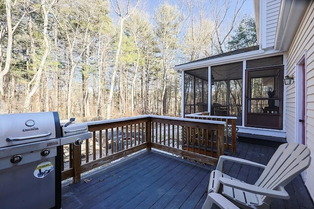 wooden terrace featuring a forest view, area for grilling, and a sunroom