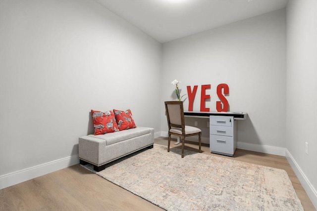 office space with baseboards and wood finished floors