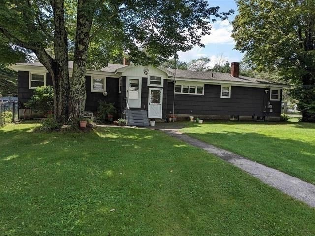 ranch-style home with a front lawn