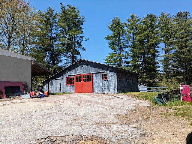 view of outdoor structure with a carport and a garage