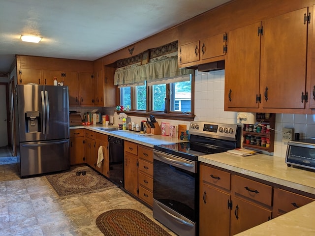 kitchen featuring sink, light tile patterned floors, decorative backsplash, and stainless steel appliances