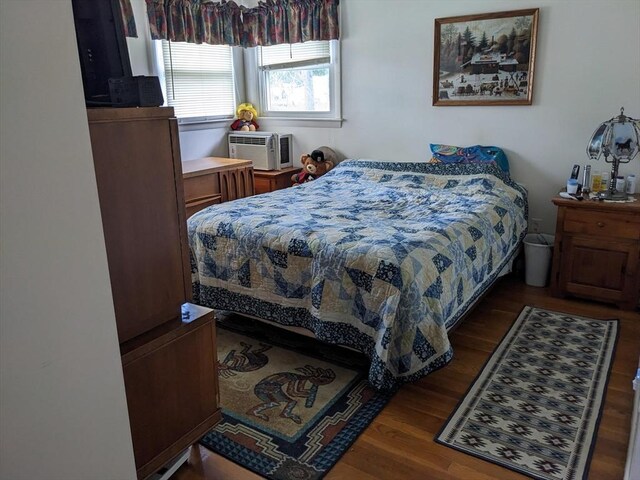 bedroom with wood-type flooring and cooling unit