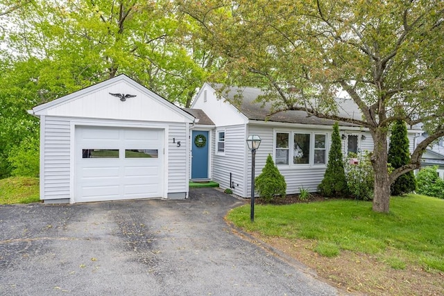15 Winslow St, Gardner, MA 01440 - single story home with a front yard, a garage, board and batten siding, and driveway