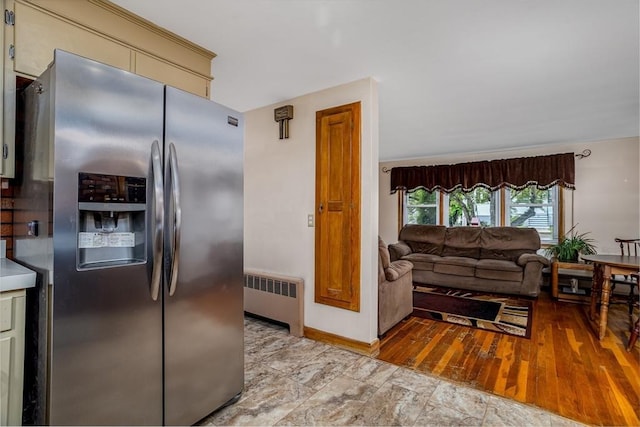 15 Winslow St, Gardner, MA 01440 - kitchen with stainless steel fridge with ice dispenser, radiator heating unit, cream cabinetry, baseboards, and open floor plan