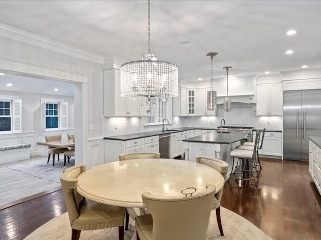 kitchen with white cabinets, pendant lighting, dark hardwood / wood-style flooring, and stainless steel appliances