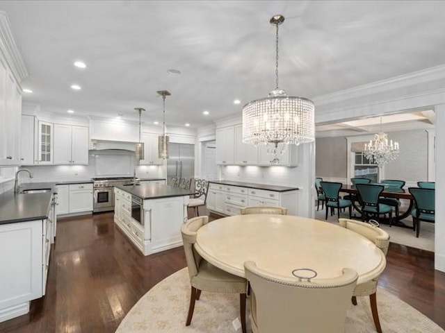 dining space featuring a chandelier, ornamental molding, sink, and dark wood-type flooring