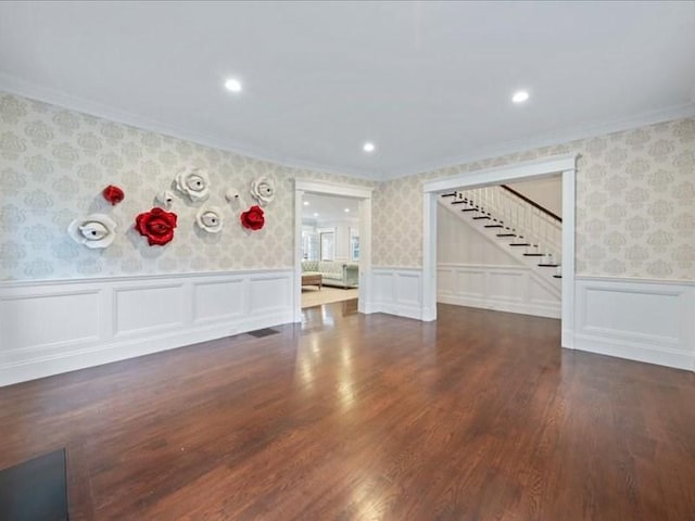 unfurnished living room featuring dark hardwood / wood-style floors and crown molding