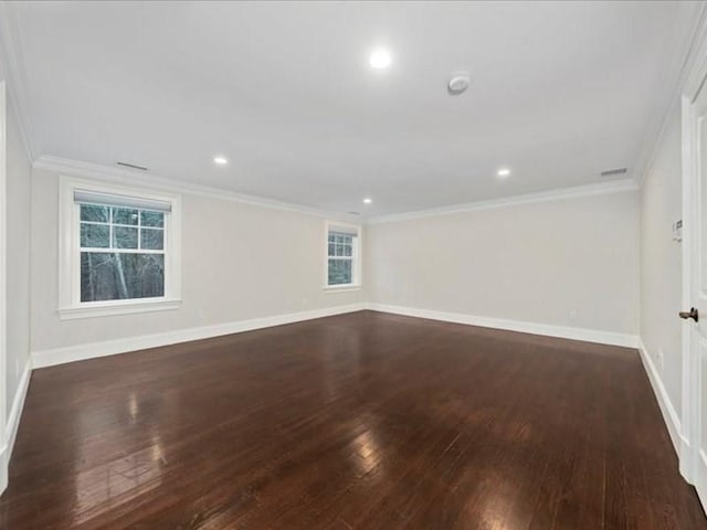 spare room with crown molding and dark hardwood / wood-style flooring