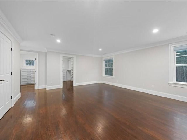 spare room featuring crown molding and dark hardwood / wood-style flooring