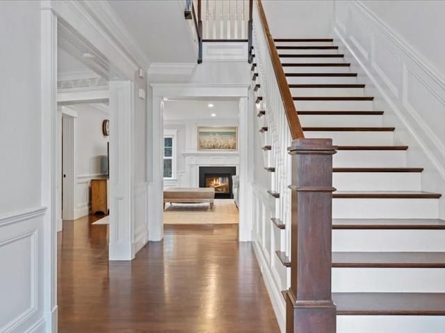 foyer featuring dark hardwood / wood-style flooring and ornamental molding