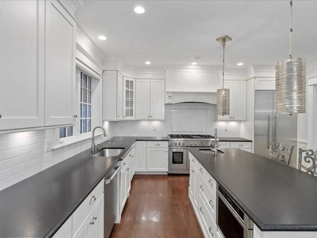 kitchen featuring pendant lighting, white cabinets, sink, and stainless steel appliances