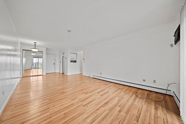 unfurnished living room with baseboard heating and light wood-style flooring